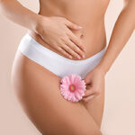 Young woman with flower on light background. Gynecology concept
